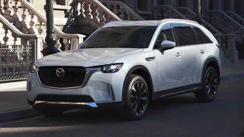 A white Mazda CX-90 parked on a city street